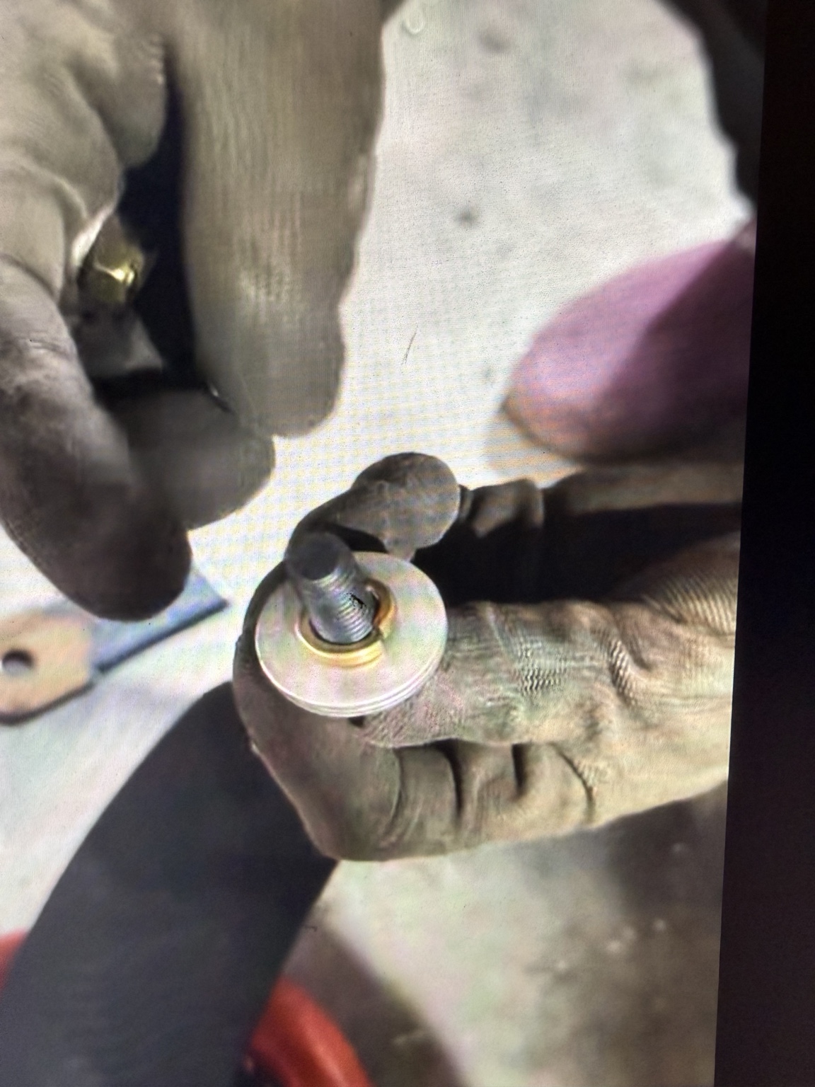 YiHui assembly video frame showing washers placed over a fully threaded bolt.